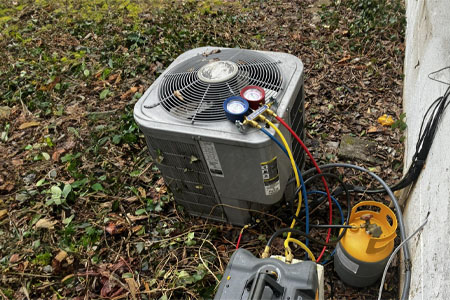 An outdoor air conditioning unit undergoing maintenance