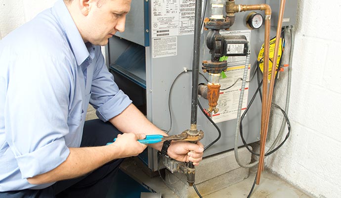 Person installing heating unit with equipment