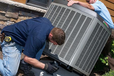 maintenance work on a large outdoor air conditioning unit